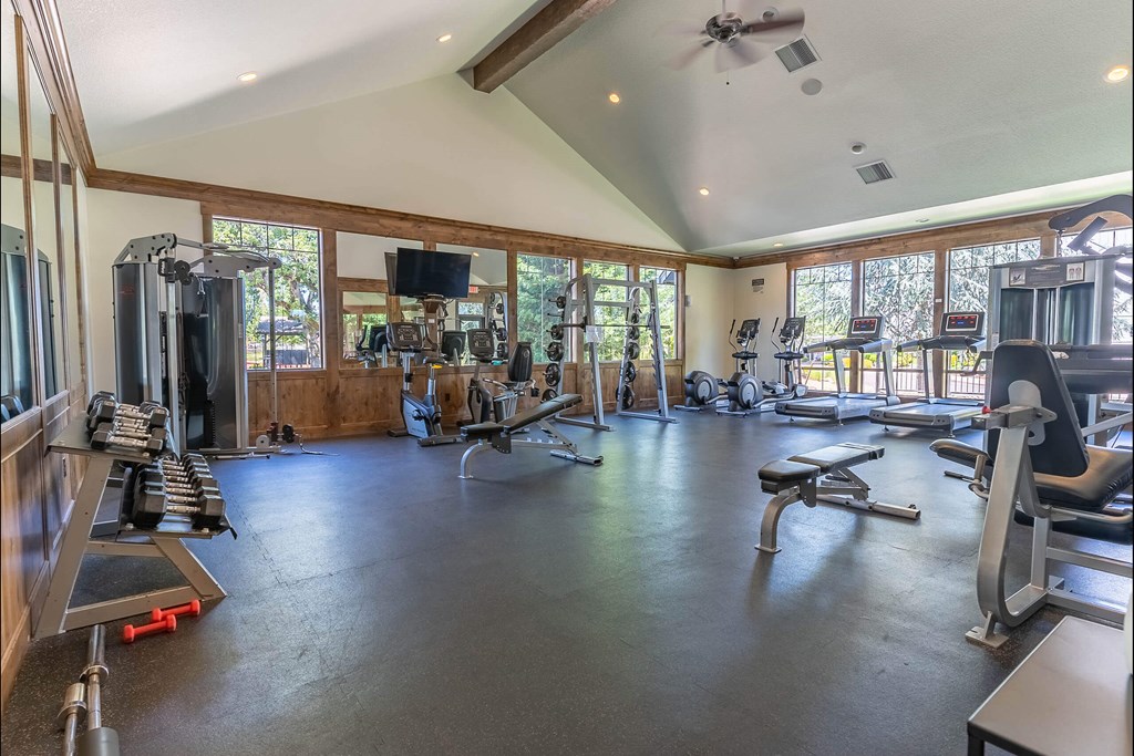 A spacious home gym with a variety of exercise equipment at Riverplace Apartment Homes, Oregon