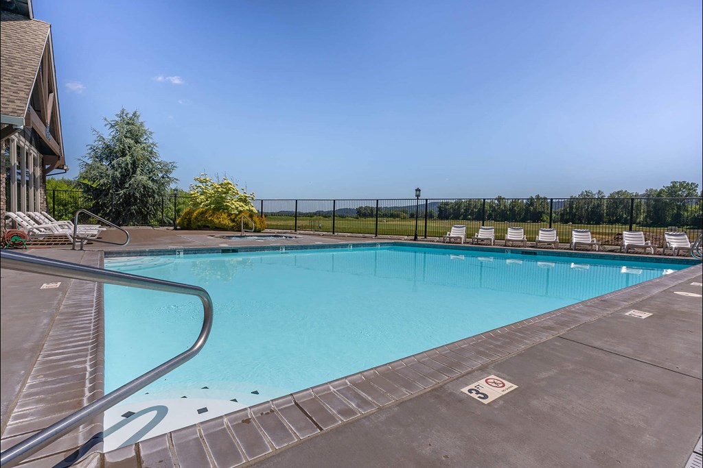A large outdoor swimming pool with a metal ladder on the left side at Riverplace Apartment Homes, Oregon, 97351