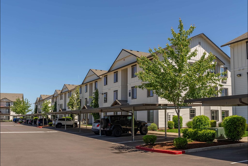 A row of houses with a tree in front of them at Riverplace Apartment Homes, Oregon, 97351