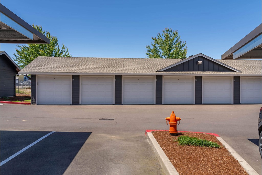 A fire hydrant is in front of a garage at Riverplace Apartment Homes, Independence, OR, 97351
