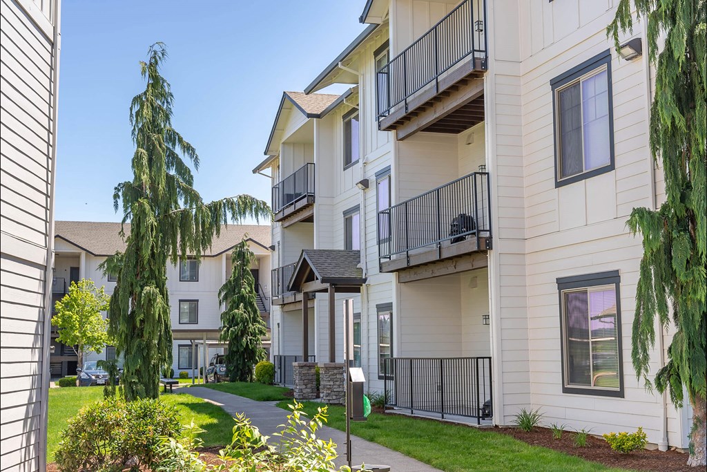 A sunny day at a residential apartment complex with a clear blue sky at Riverplace Apartment Homes, Independence, 97351