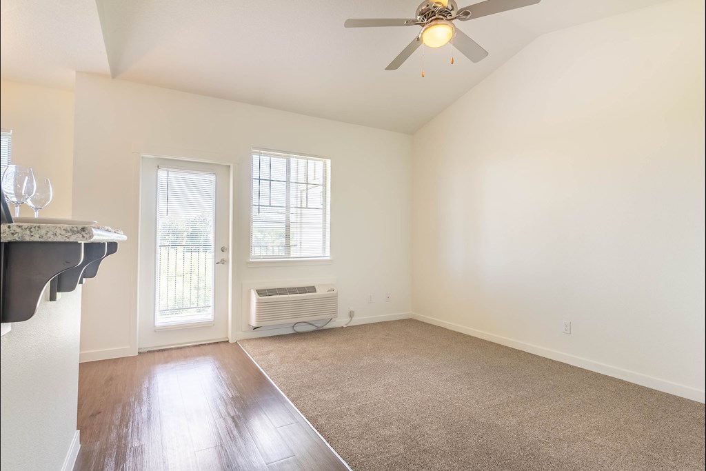 A room with a ceiling fan and a window at Riverplace Apartment Homes, Oregon