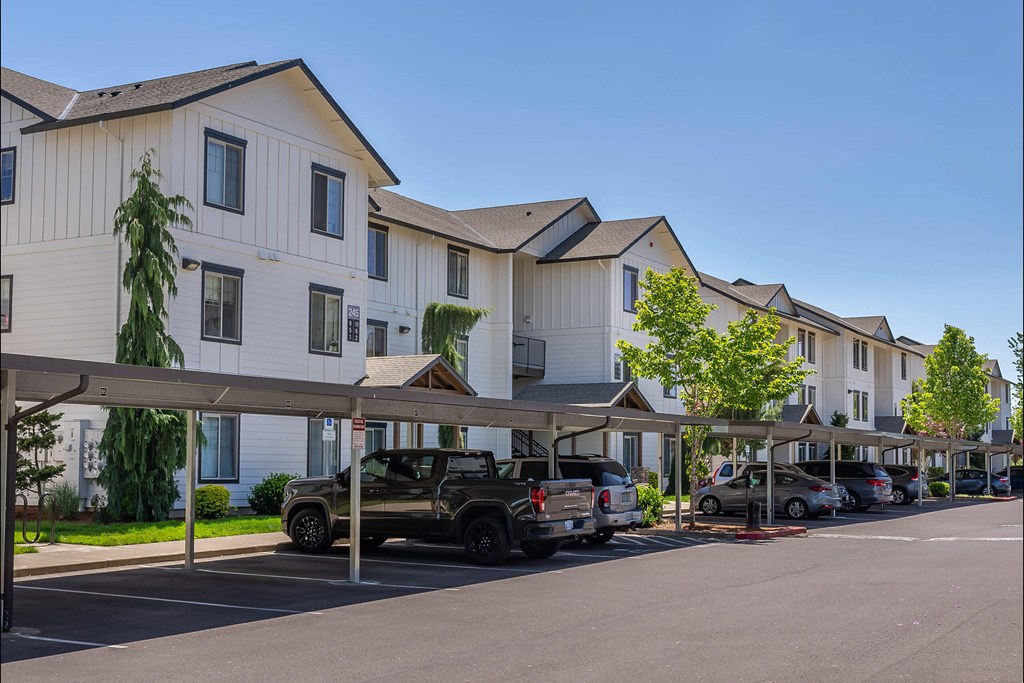 A row of houses with cars parked in front at Riverplace Apartment Homes, Independence, OR