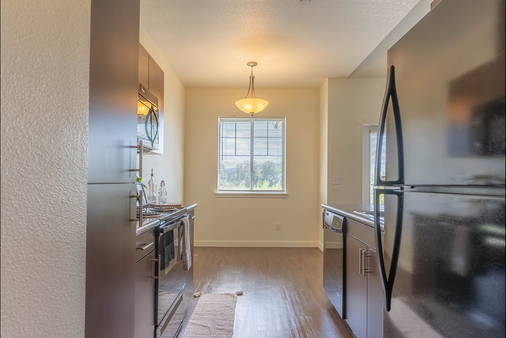 A kitchen with a refrigerator, stove, and oven at Riverplace Apartment Homes, Independence, OR