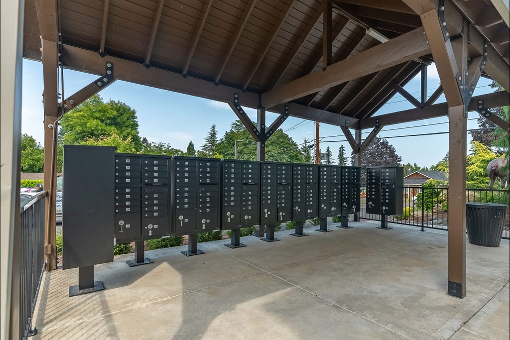 A row of black plaques are on display under a wooden roof at Sandyplace Apartment Homes, Oregon