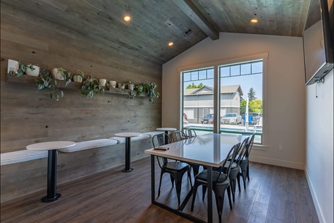 A dining area with a long table and chairs.