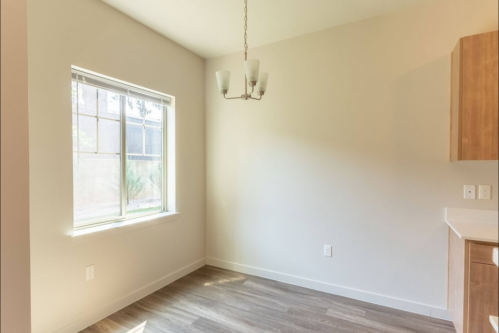 A room with a window and a hanging light fixture at Sandyplace Apartment Homes, Oregon, 97055