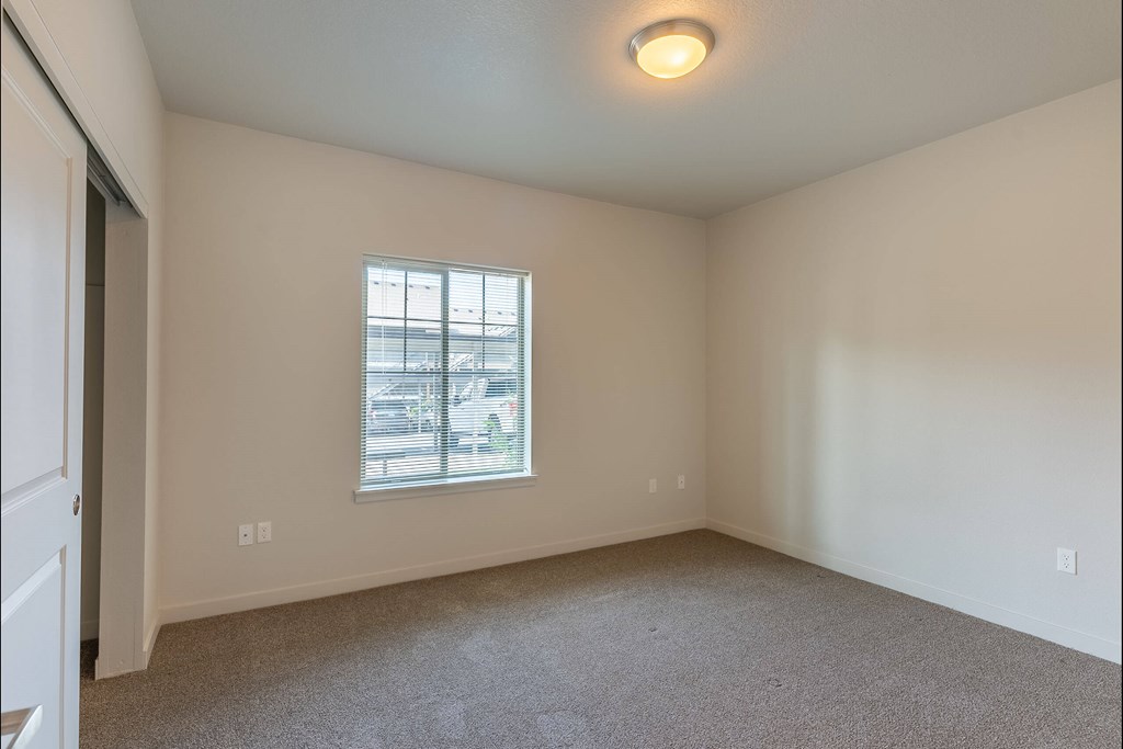 A room with a window and car view outside at Sandyplace Apartment Homes, Sandy, 97055