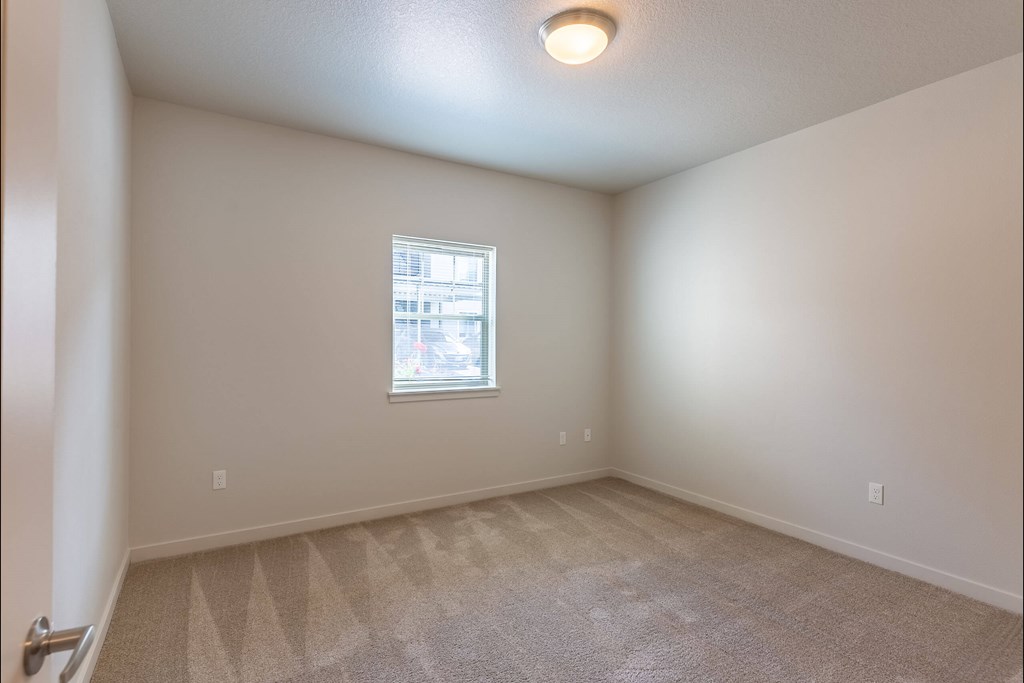 A room with a window and carpeted floor at Sandyplace Apartment Homes, Sandy, 97055