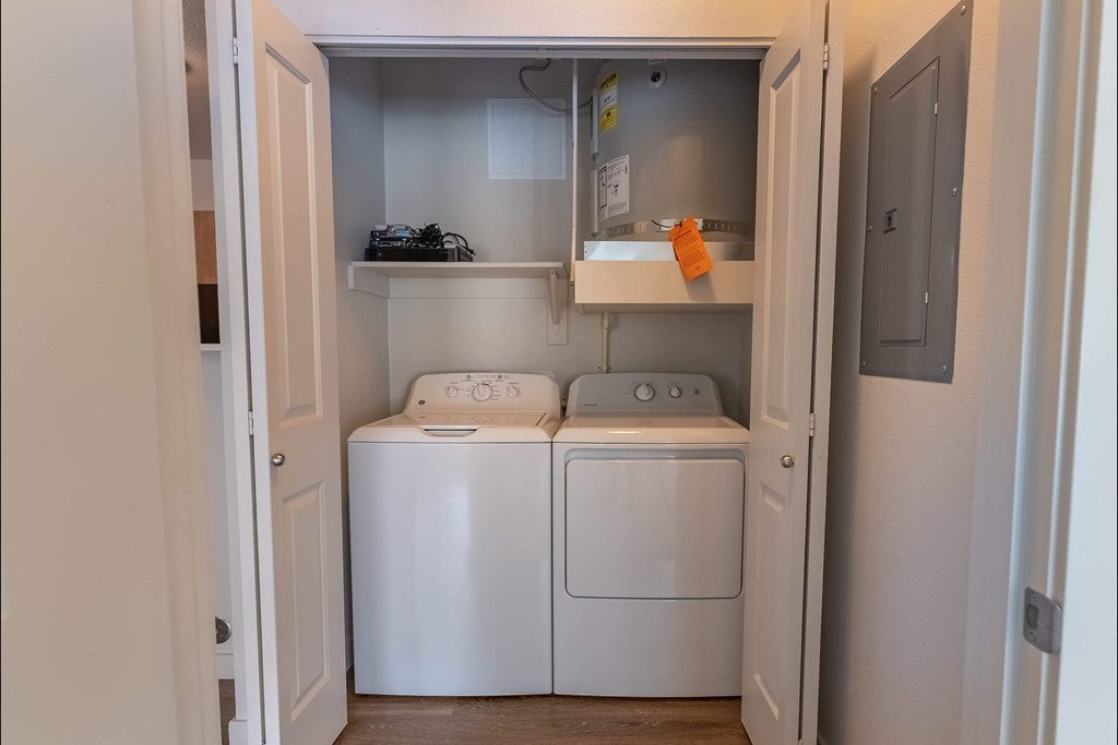 A small laundry room with a washer and dryer at Sandyplace Apartment Homes, Oregon