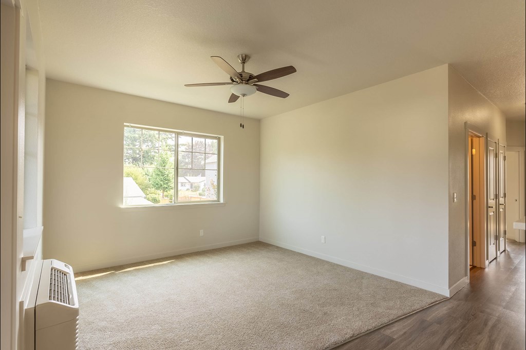 A room with a window and a ceiling fan at Sandyplace Apartment Homes, Sandy, Oregon