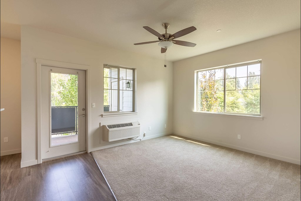 A room with a ceiling fan and two windows at Sandyplace Apartment Homes, Sandy, OR