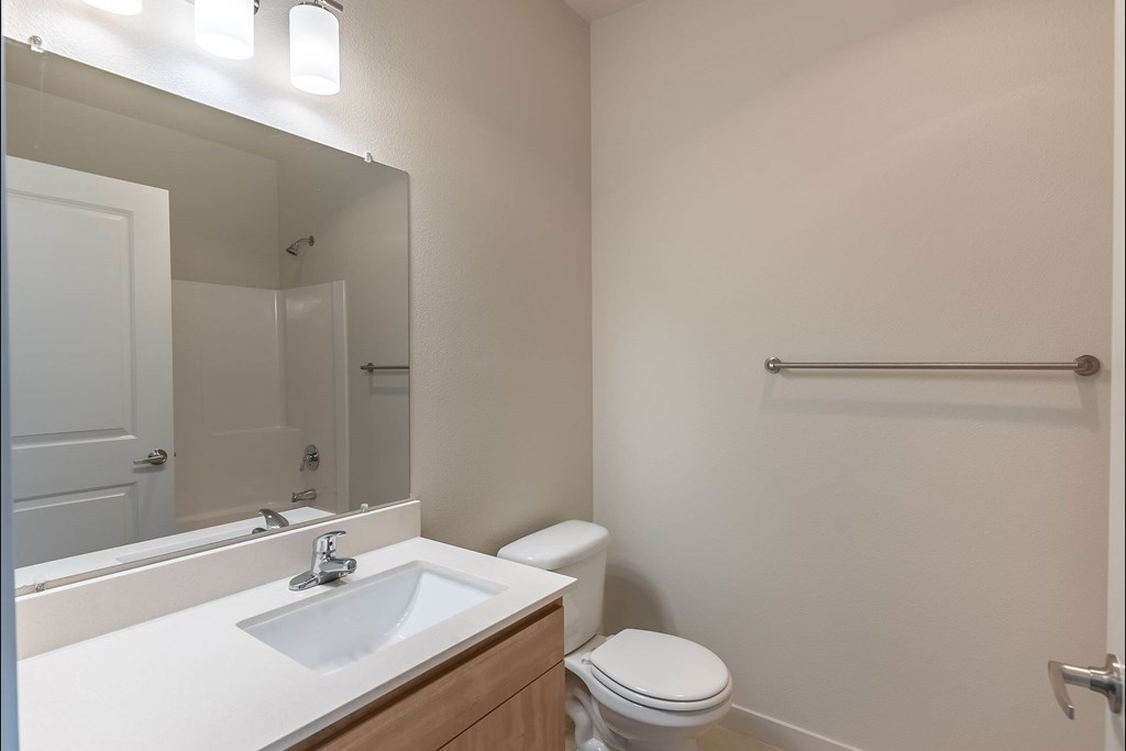 A white sink and toilet in a small bathroom at Sandyplace Apartment Homes, Sandy, OR