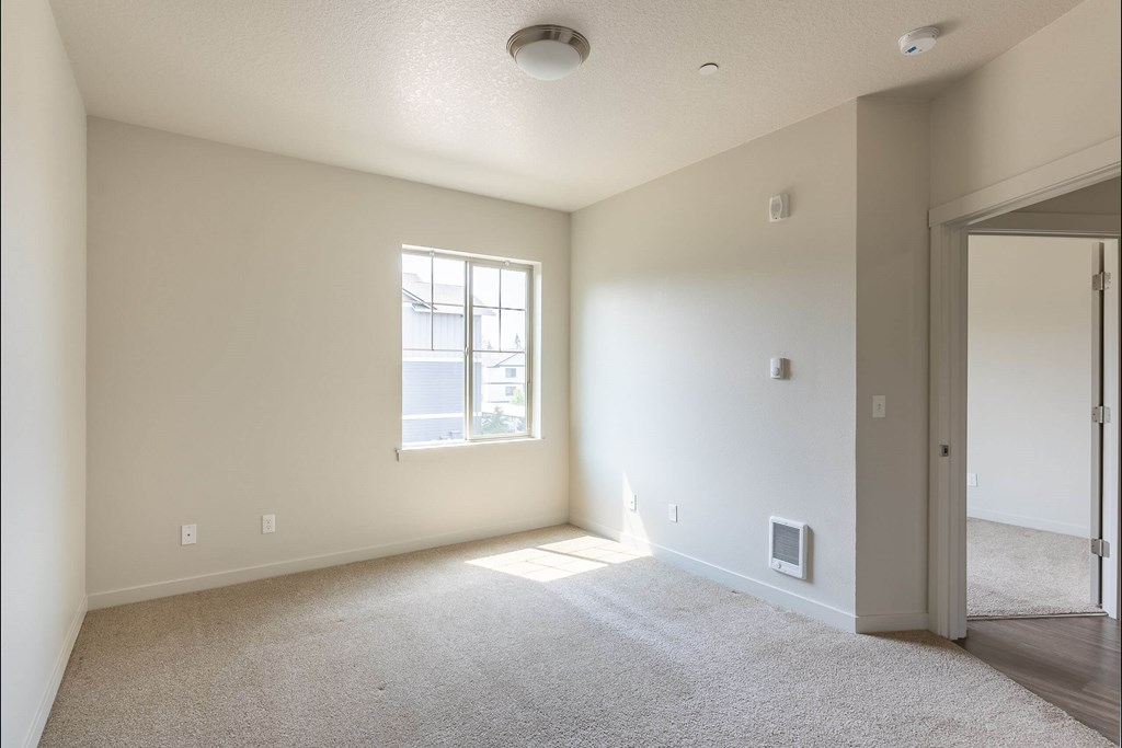 A room with a window and a carpeted floor at Sandyplace Apartment Homes, Sandy, 97055