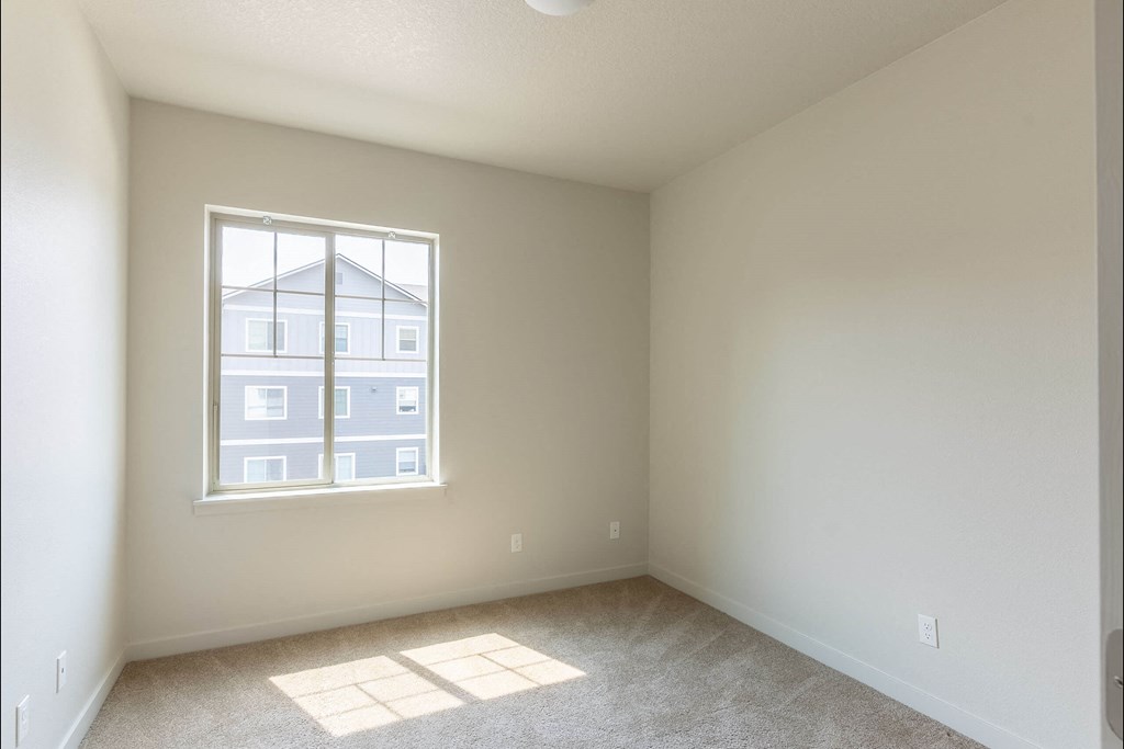 A room with a window and a view of a building outside at Sandyplace Apartment Homes, Sandy, OR, 97055