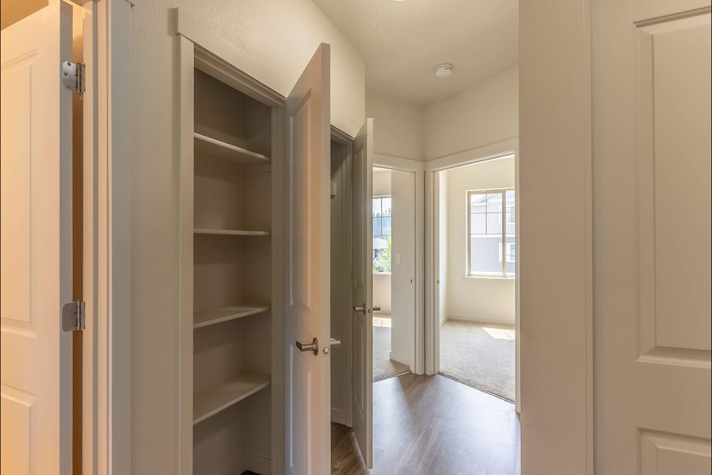 A white pantry with an open door leading to a hallway at Sandyplace Apartment Homes, Sandy, 97055