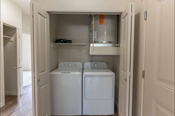 A small laundry room with a washer and dryer.