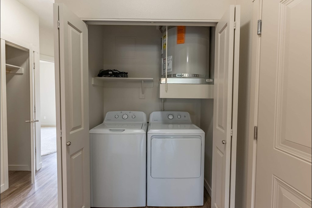 A small laundry room with a washer and dryer at Sandyplace Apartment Homes, Sandy, Oregon