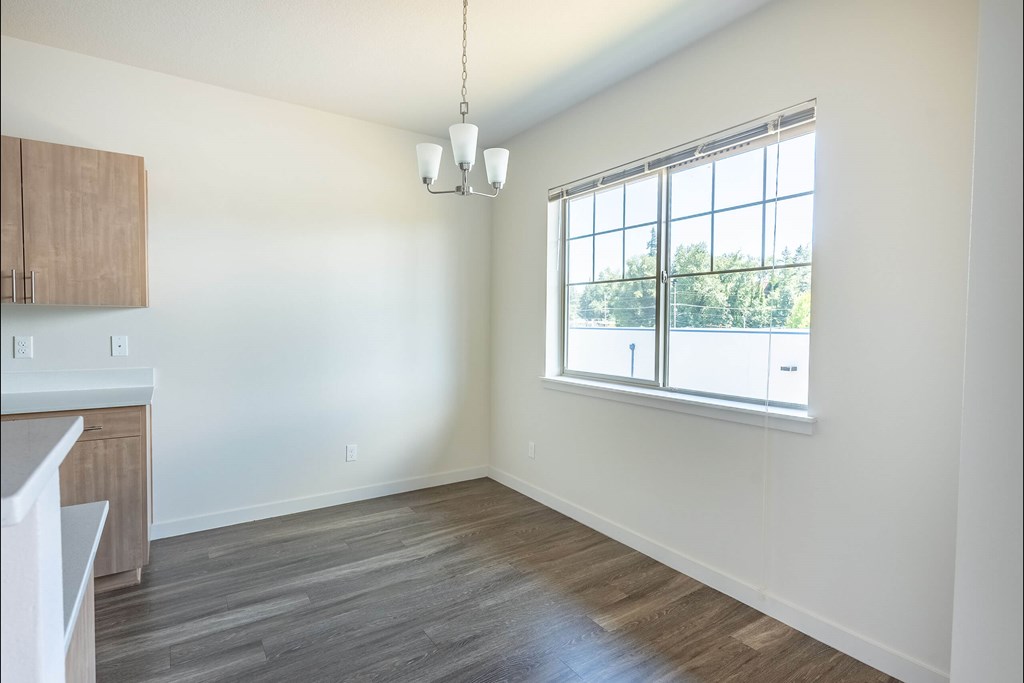 A room with a window and a kitchen area at Silverplace Apartment Homes, Oregon, 97381