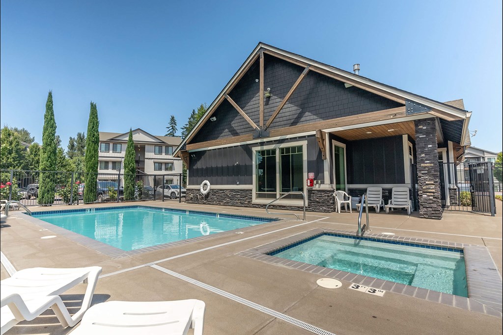 A house with a pool in front of it at Silverplace Apartment Homes, Oregon