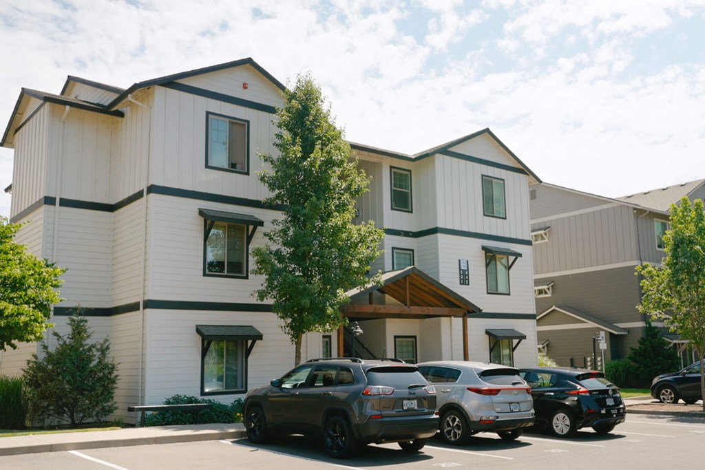 A row of cars parked in front of a building at Silverplace Apartment Homes, Oregon