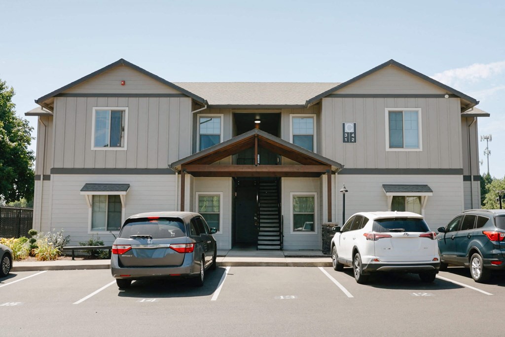 A grey building with a car parked in front at Silverplace Apartment Homes, Silverton, OR, 97381