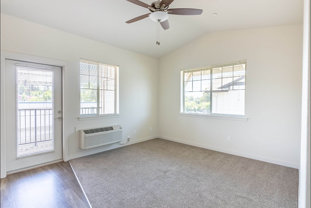 A room with a ceiling fan and two windows at Silverplace Apartment Homes, Silverton, OR