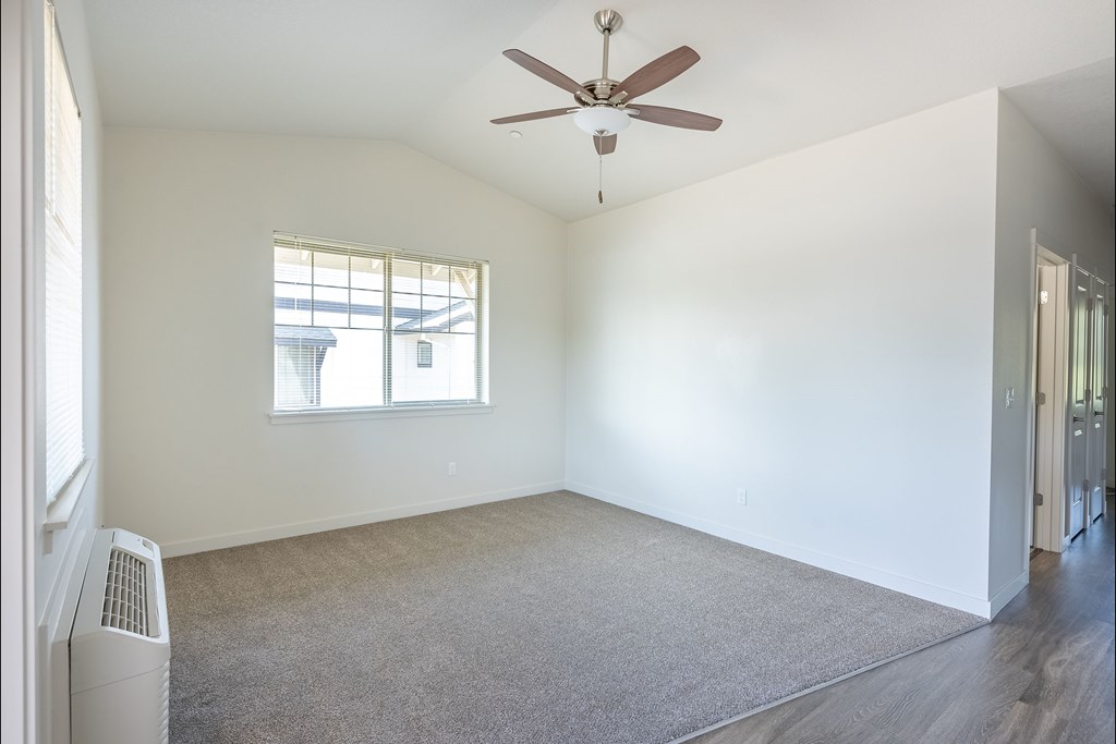 A room with a ceiling fan and a window at Silverplace Apartment Homes, Silverton, OR