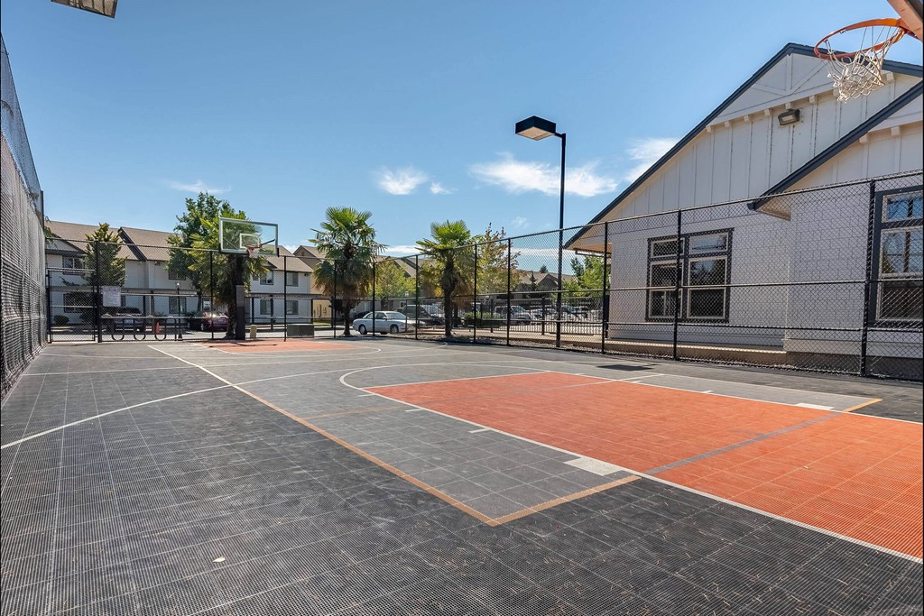 A basketball court with a basketball hoop and a basketball net at Stoneplace Apartment Homes, Molalla
