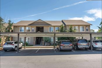 A building with a parking lot in front of it.