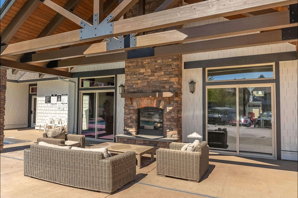 A patio with a fireplace and seating area at Stoneplace Apartment Homes, Molalla, OR