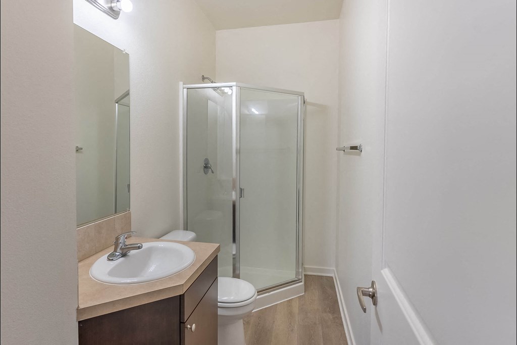 A bathroom with a sink, toilet, and shower at Stoneplace Apartment Homes, Oregon