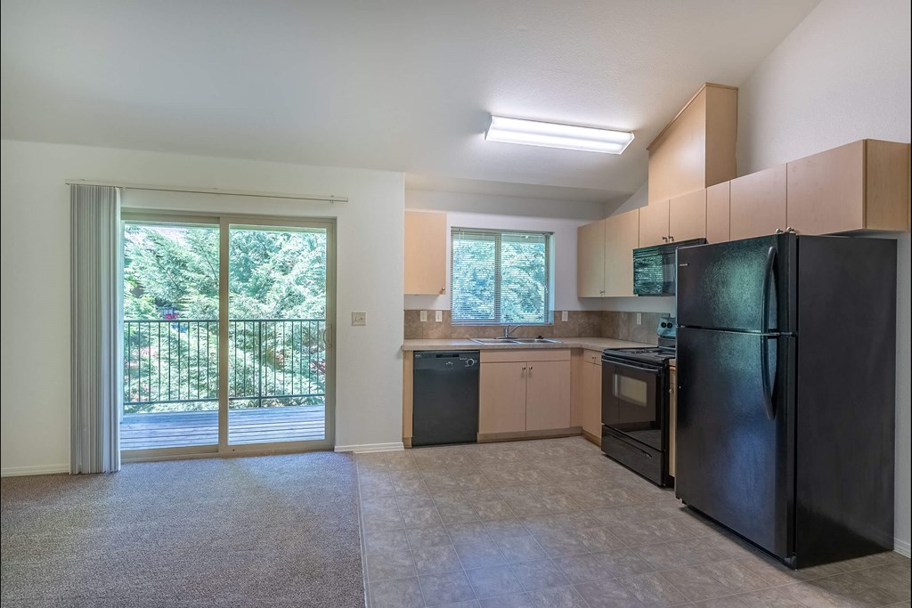 A kitchen with black appliances and a black refrigerator at Stoneplace Apartment Homes, Molalla, Oregon