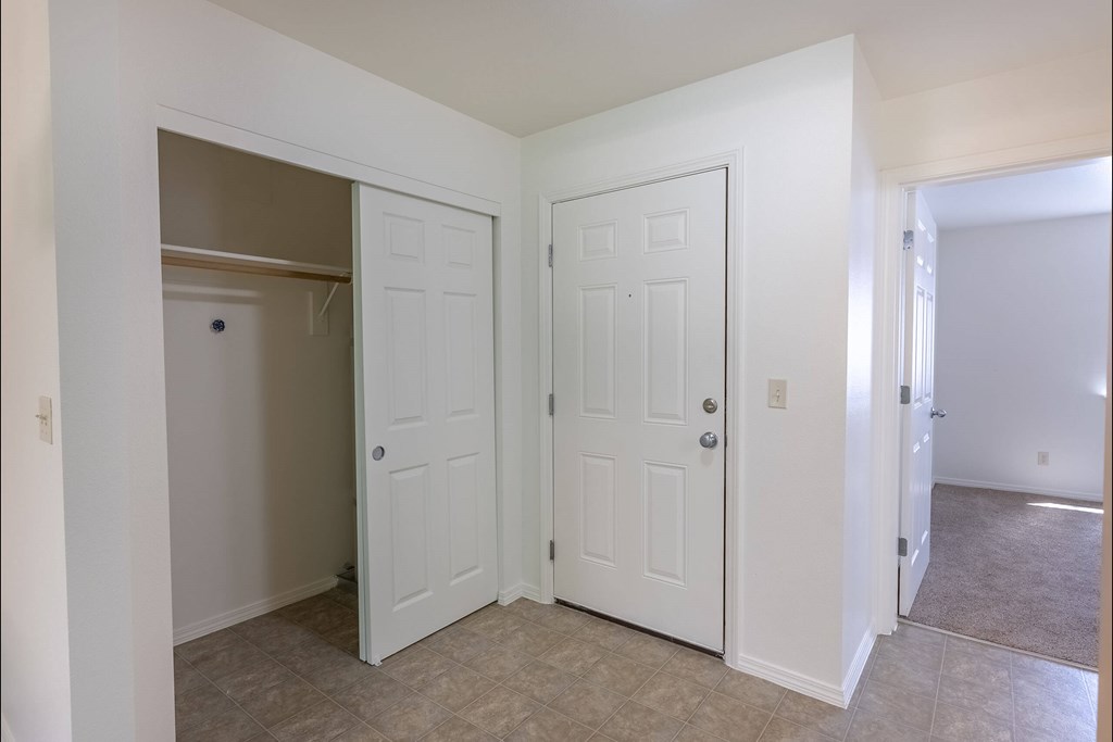 A white door is open to a hallway at Stoneplace Apartment Homes, Molalla