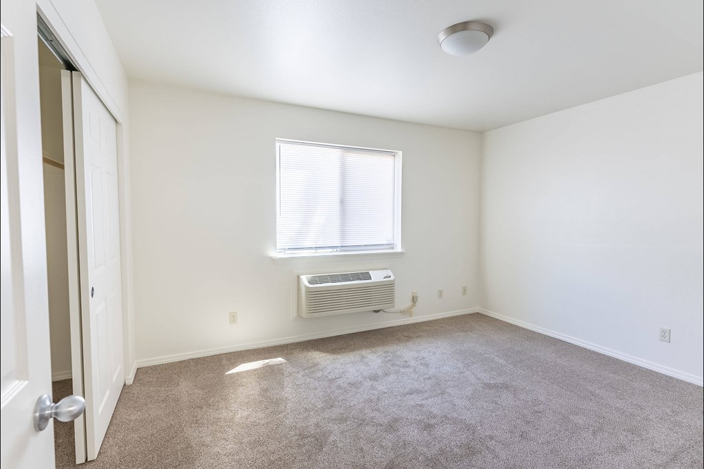 A room with a window and a carpeted floor at Stoneplace Apartment Homes, Molalla, Oregon