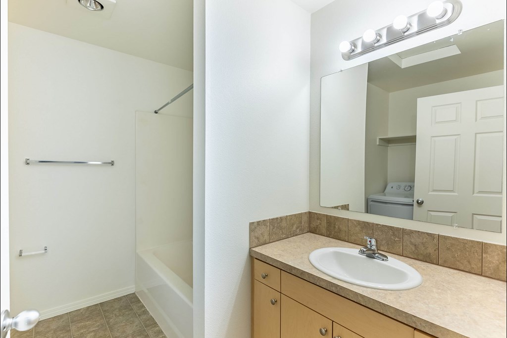 A bathroom with a sink, mirror, and towel rack at Stoneplace Apartment Homes, Molalla, 97038