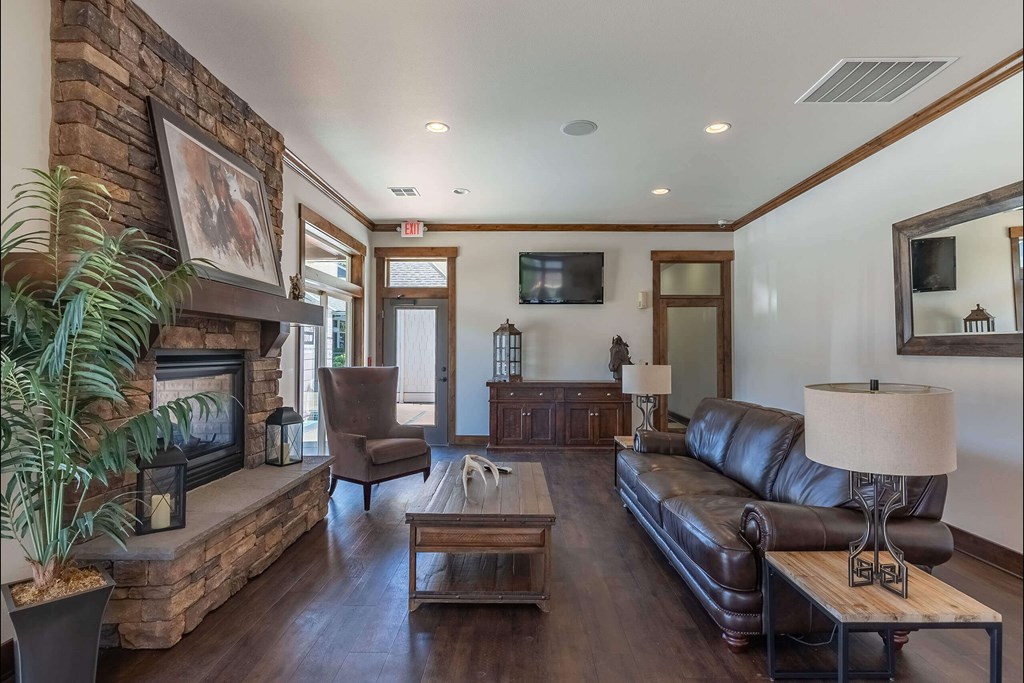 A living room with a fireplace and a couch at Stoneplace Apartment Homes, Oregon, 97038