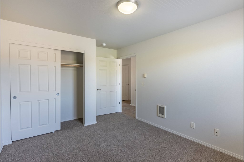 A white door is on the left and a white closet door is on the right at Stoneplace Apartment Homes, Molalla, OR, 97038