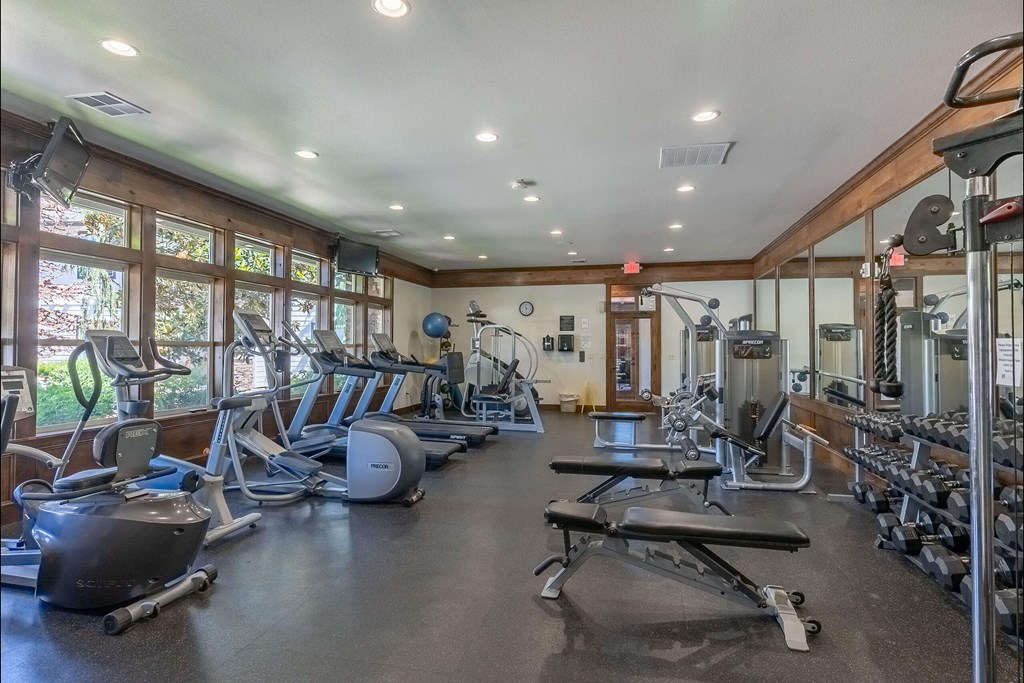 A spacious gym with a variety of equipment including treadmills, weights, and exercise machines. A spacious gym with a variety of equipment including treadmills, weights, and exercise machines at Stoneplace Apartment Homes, Molalla, 97038