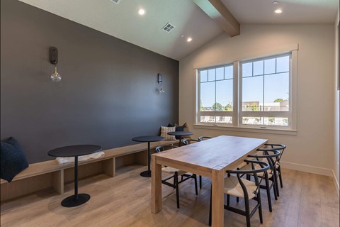 A dining room with a table and chairs.