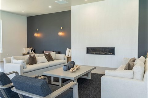 A modern living room with a fireplace and a grey coffee table.