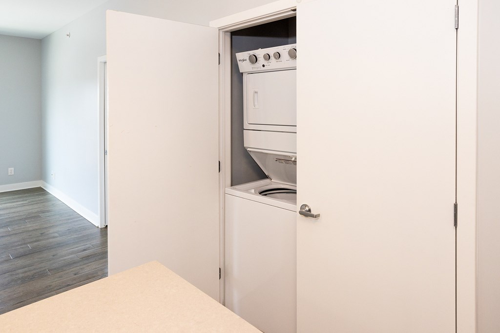 A white oven is built into a wall in a kitchen.