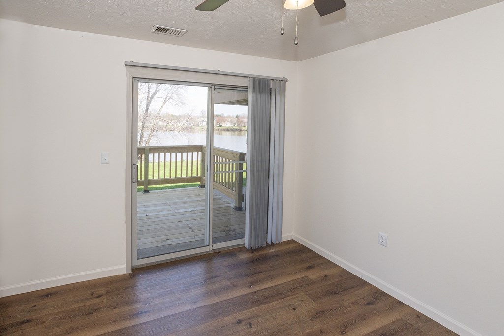 A room with a sliding glass door leading to a deck.