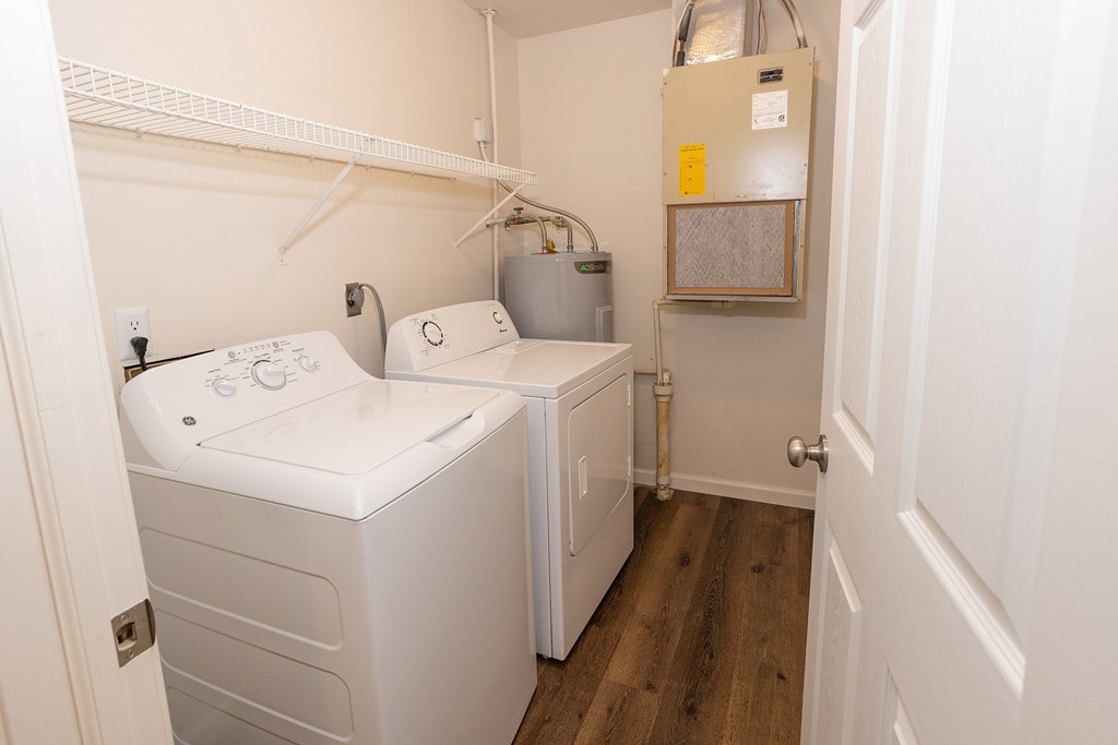 A small laundry room with a washer and dryer.