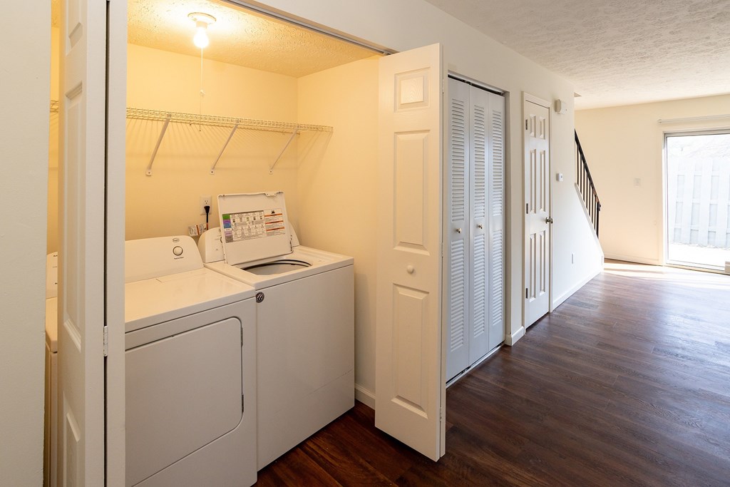 A small laundry room with a washer and dryer.