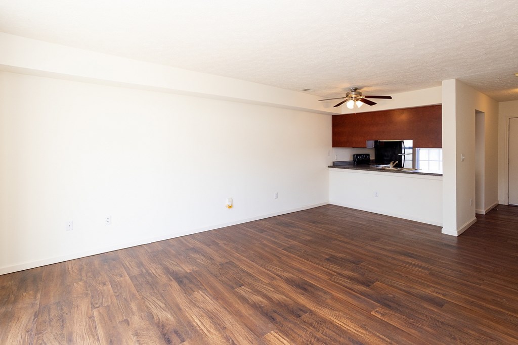 A room with wooden floors and a ceiling fan.