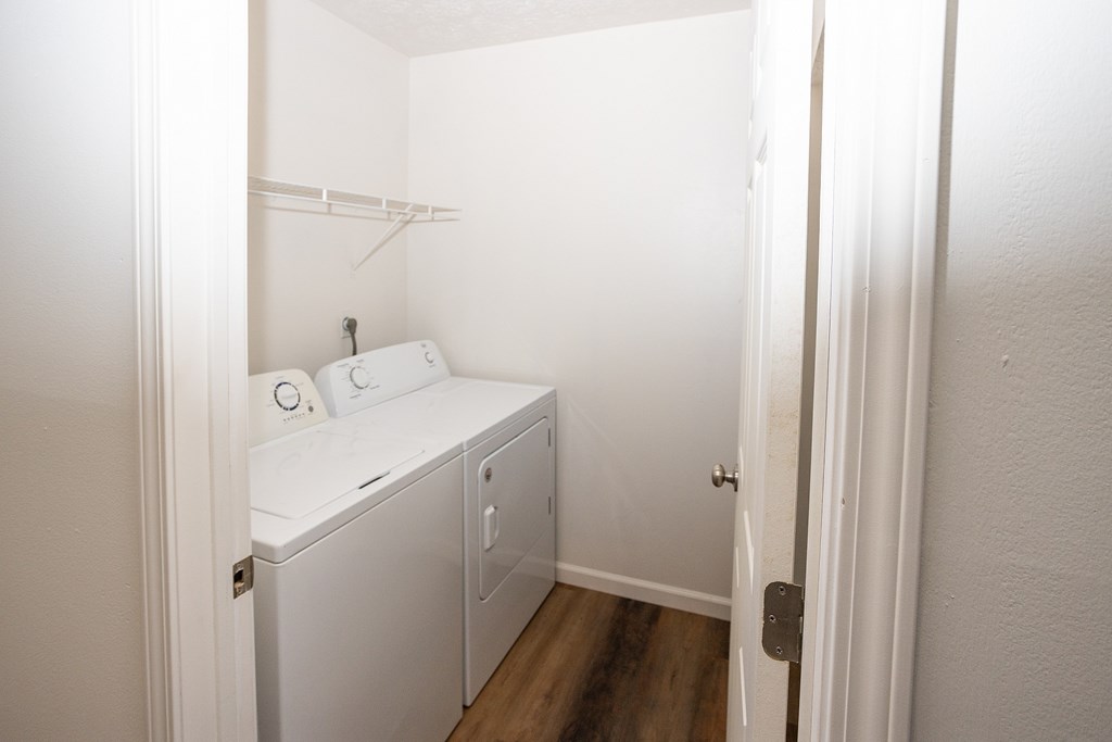 A small white laundry room with a washer and dryer.