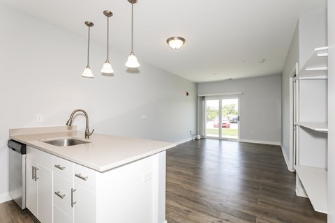 A kitchen with white cabinets and a sink.