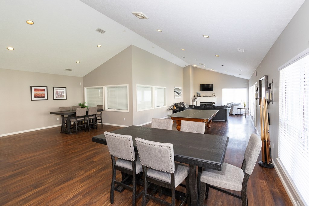 A dining room with a dark wood table and chairs.