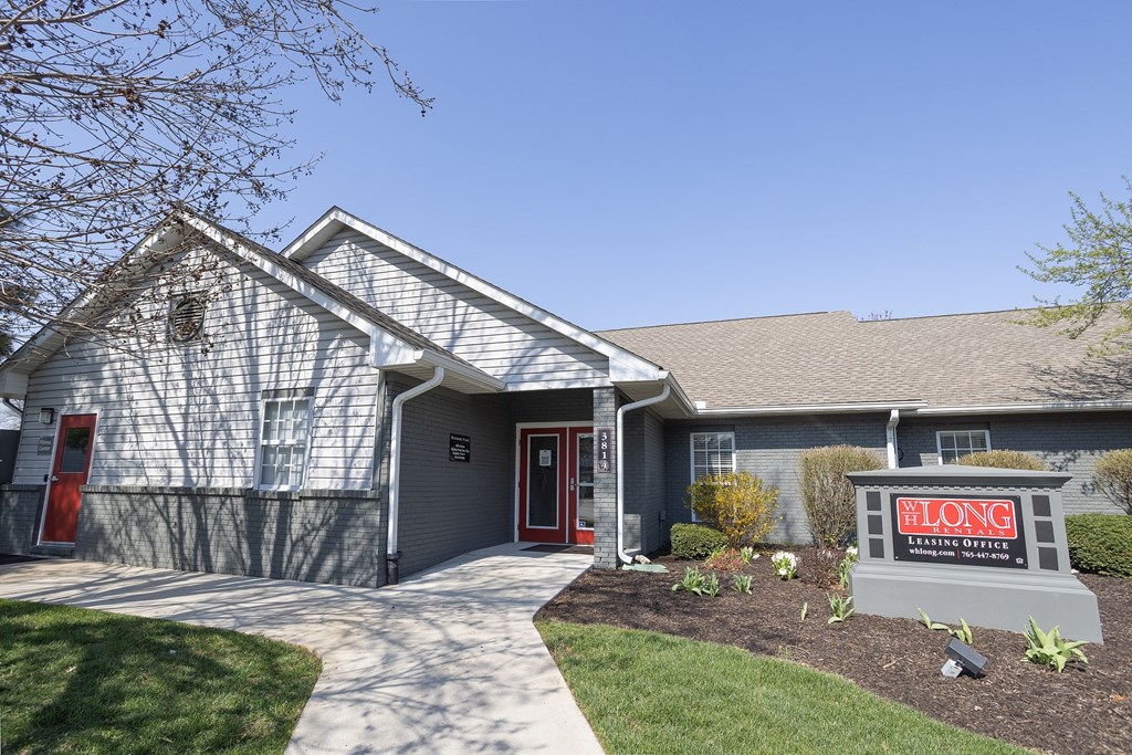 A house with a sign in front that says "BLONG".